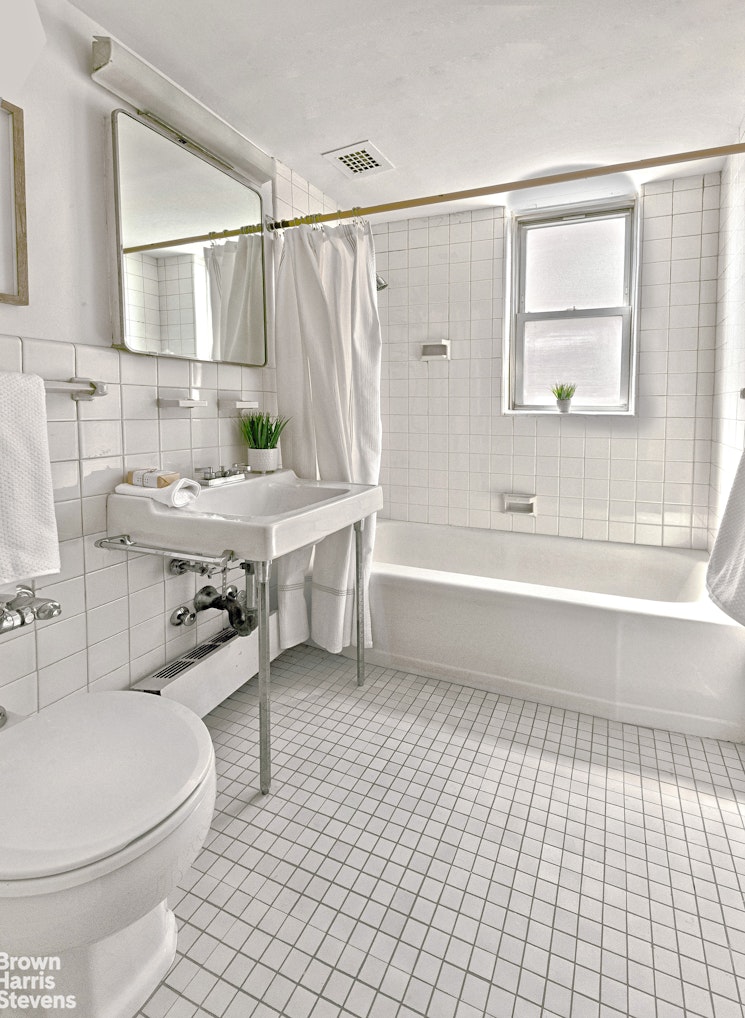 35 Sutton Place, Unit 14F Manhattan, NY 10022 - Photo 9 of 15 a bathroom with a sink a toilet and bathtub