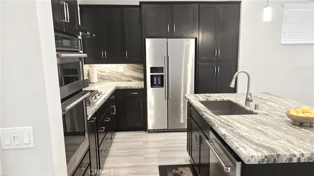 a kitchen with a refrigerator and a sink