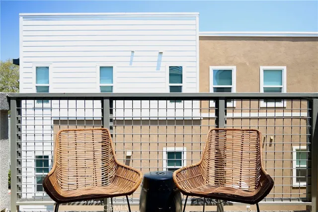 a view of a balcony with a table and chairs