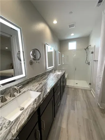 a large kitchen with a sink and a wooden floor
