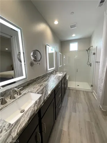 a large kitchen with a sink and a wooden floor