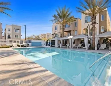 a view of an house with swimming pool and chairs