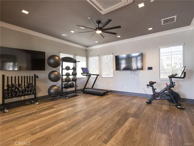 a living room with furniture gym equipment and a view of kitchen