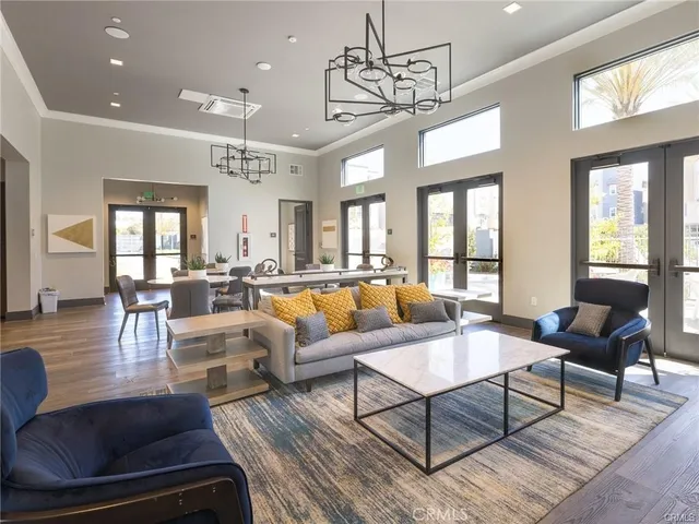a living room with lots of furniture and a chandelier