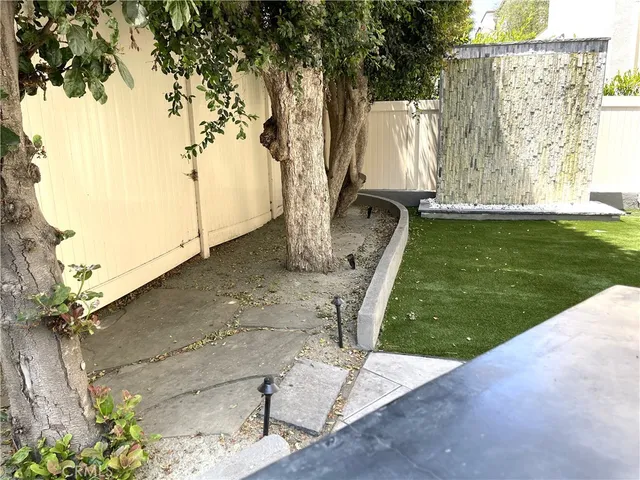 a view of a backyard with large trees