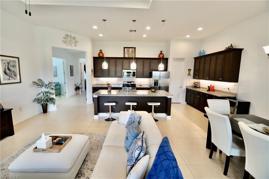 2956 Willow Ridge Court Fort Myers, FL 33905 - Photo 2 of 24 a living room with furniture and a flat screen tv