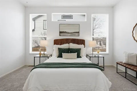 a bedroom with a large bed and a window