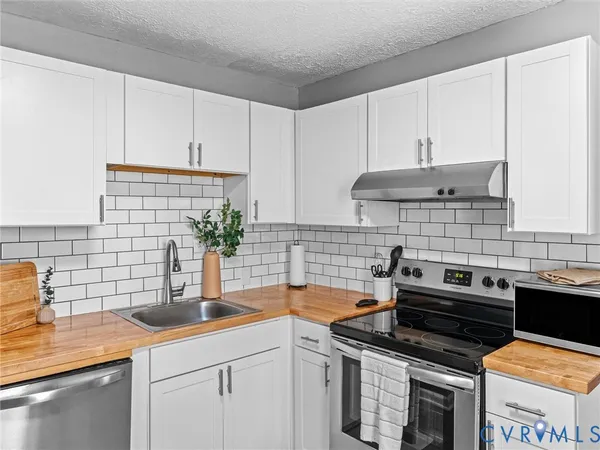a kitchen with stainless steel appliances granite countertop a sink and cabinets