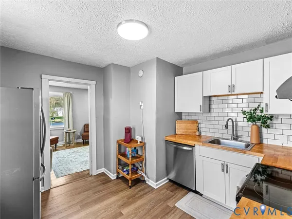 a kitchen that has a lot of cabinets a sink and appliances in it