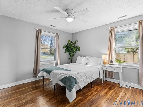a bedroom with a large bed and a large window