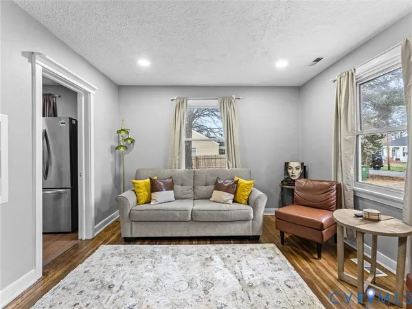 a living room with furniture and a rug