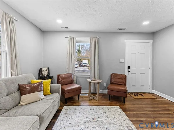 a living room with furniture ceiling fan and a rug