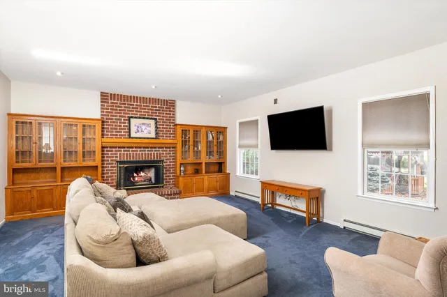 a living room with furniture fireplace and flat screen tv