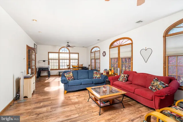 a living room with furniture a fireplace and a large window