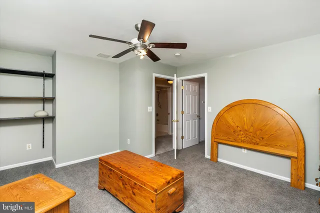 a living room with a bed and a dresser