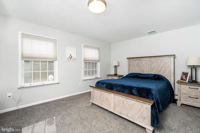 a bedroom with a bed lamp and window