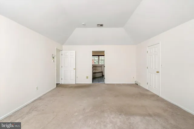 an empty room with an entrance and door