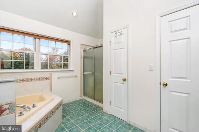 a bathroom with a tub sink and window