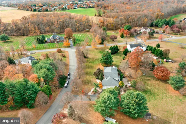 an aerial view of residential houses with outdoor space and river