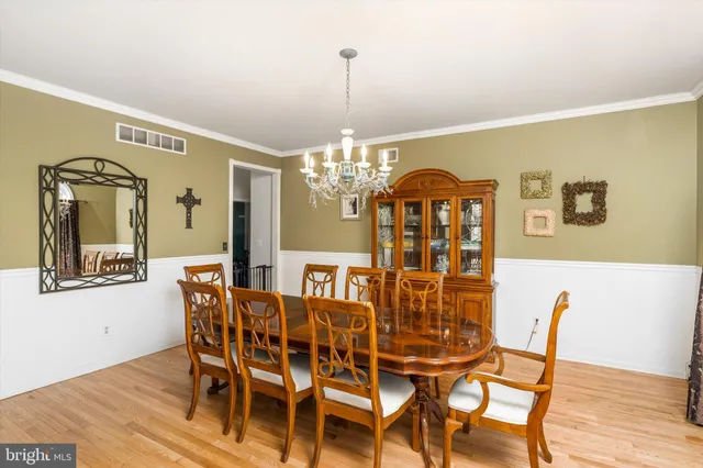a view of a dining room with furniture and chandelier