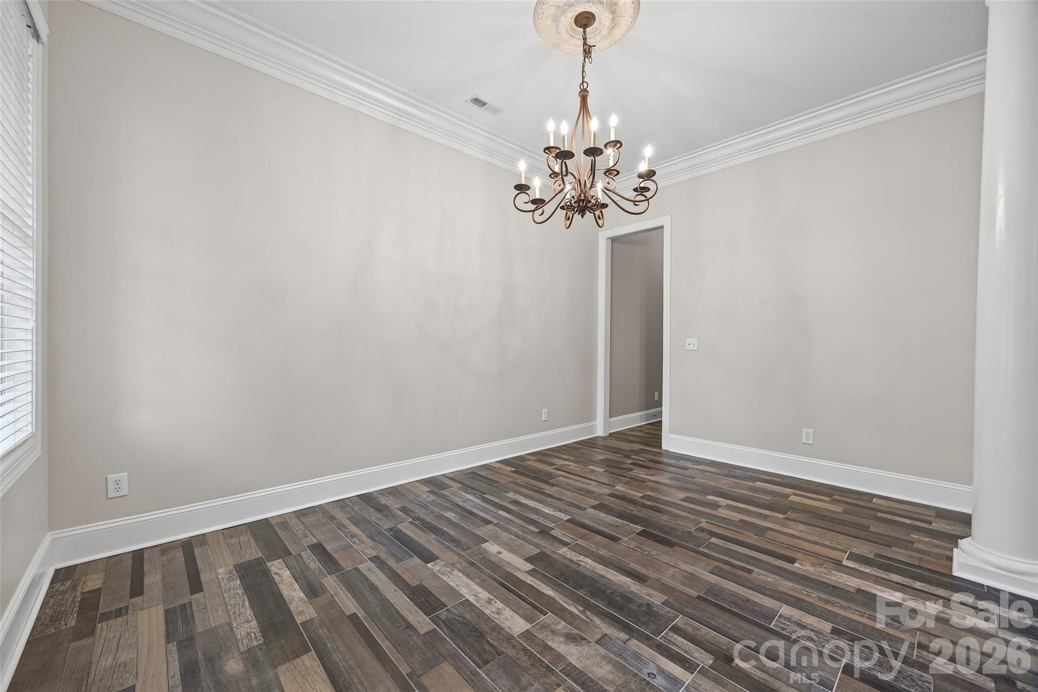 1576 Abercorn Street Northwest Concord, NC 28027 - Photo 13 of 48 a view of an empty room with a chandelier