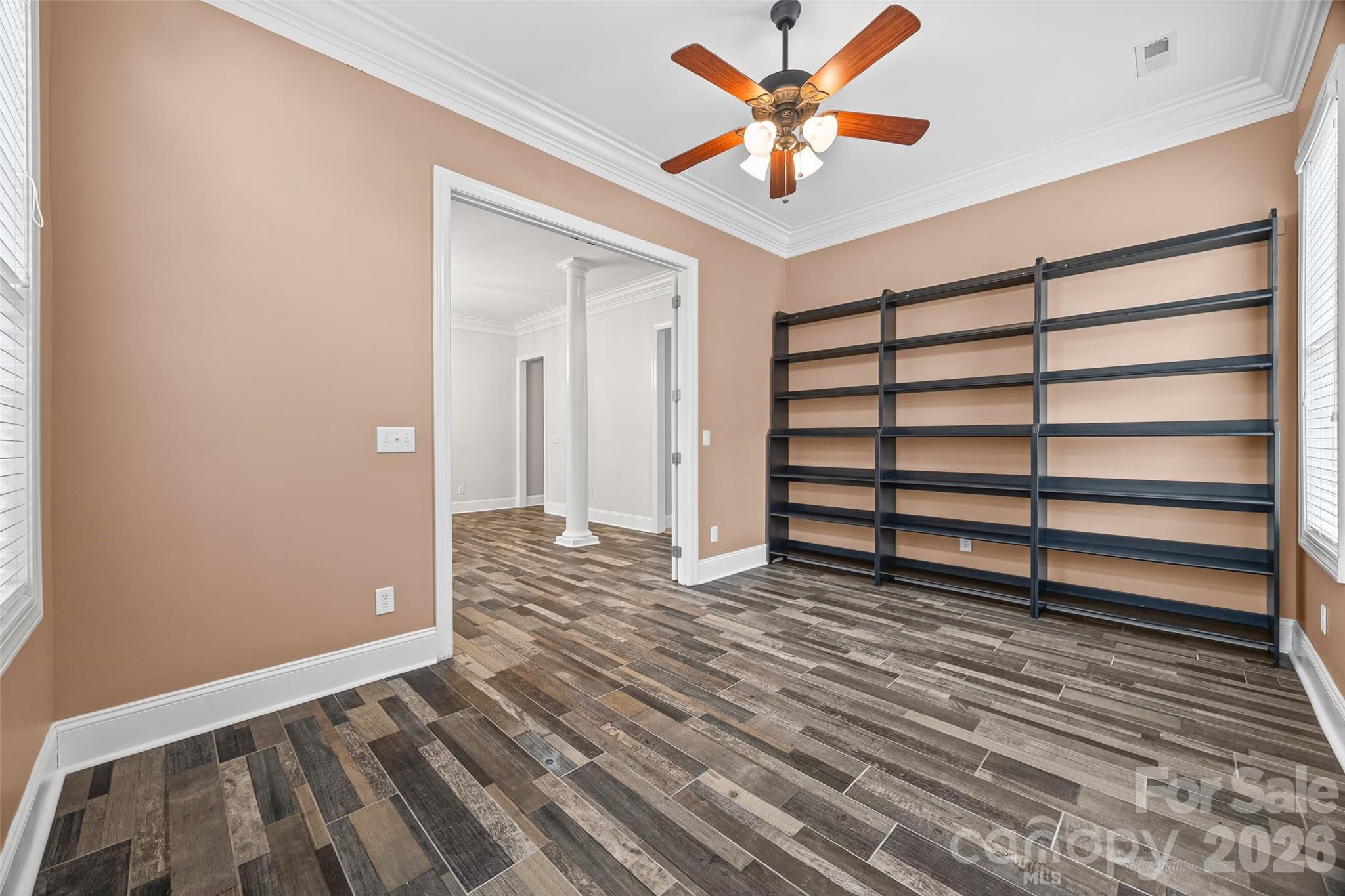 1576 Abercorn Street Northwest Concord, NC 28027 - Photo 15 of 48 a view of a room with wooden floor and a ceiling fan