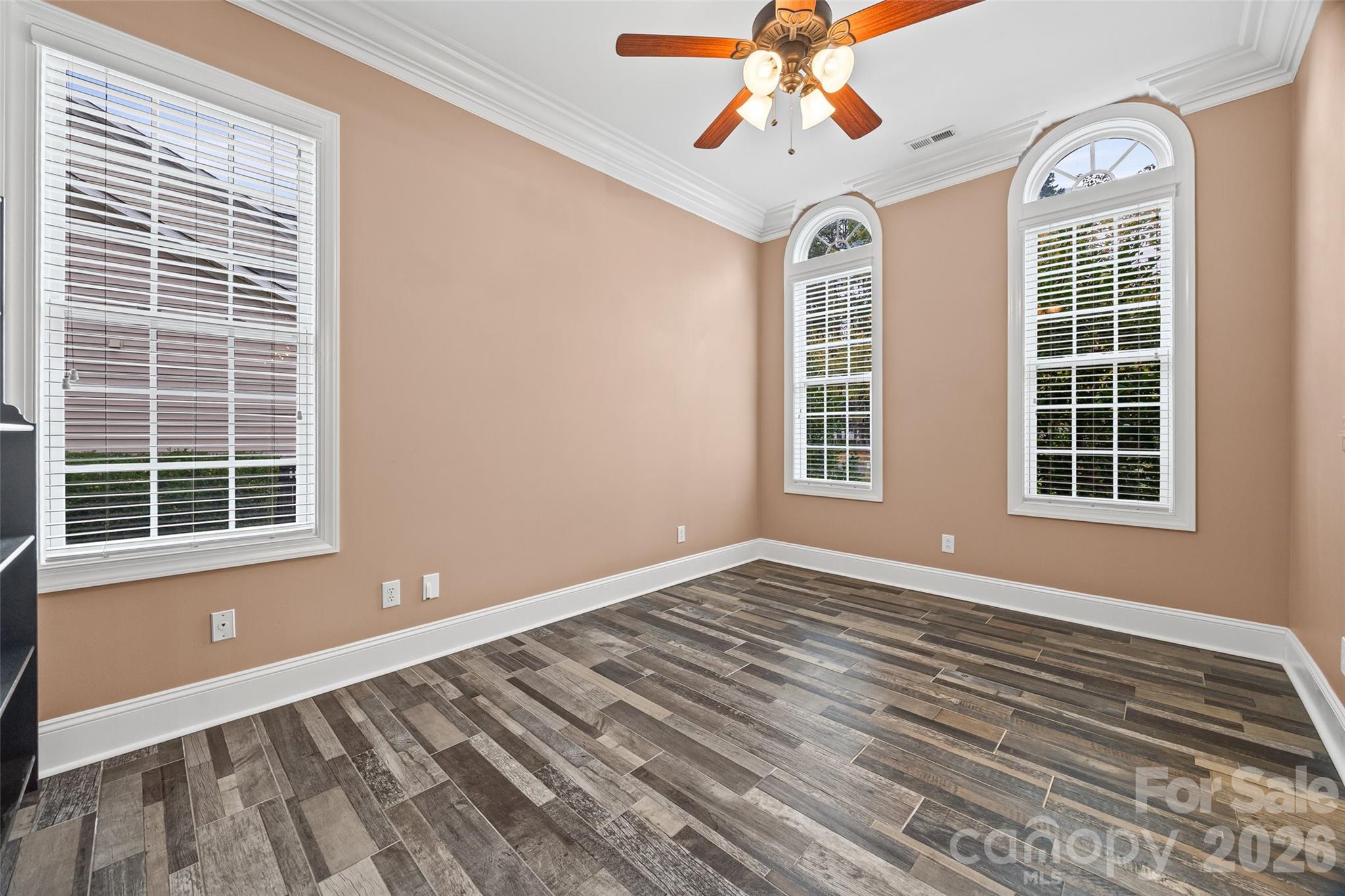 1576 Abercorn Street Northwest Concord, NC 28027 - Photo 16 of 48 a view of an empty room with a window and wooden floor
