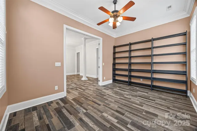 a view of a livingroom with a ceiling fan and window