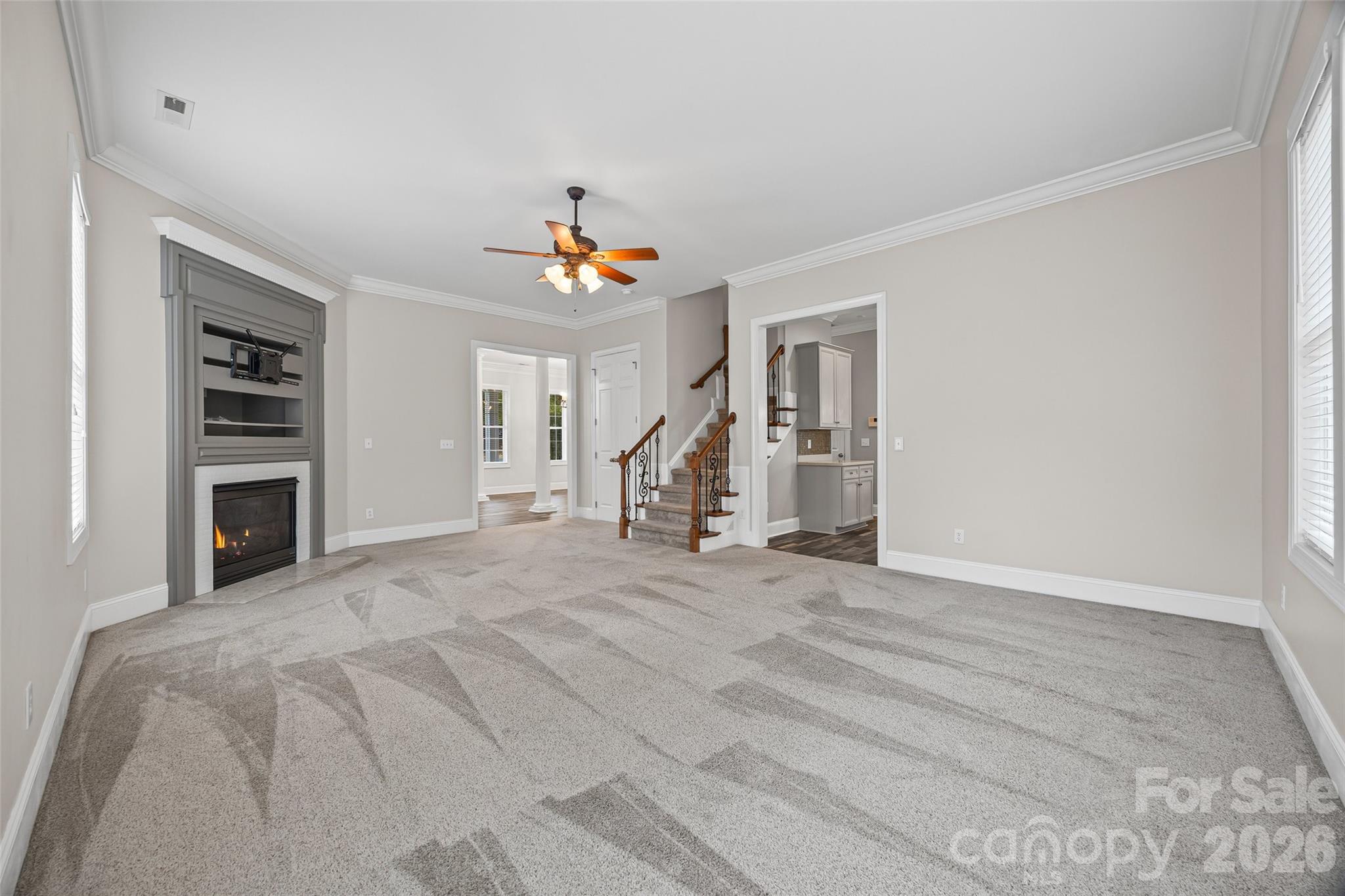 1576 Abercorn Street Northwest Concord, NC 28027 - Photo 19 of 48 a view of a livingroom with wooden floor and a ceiling fan