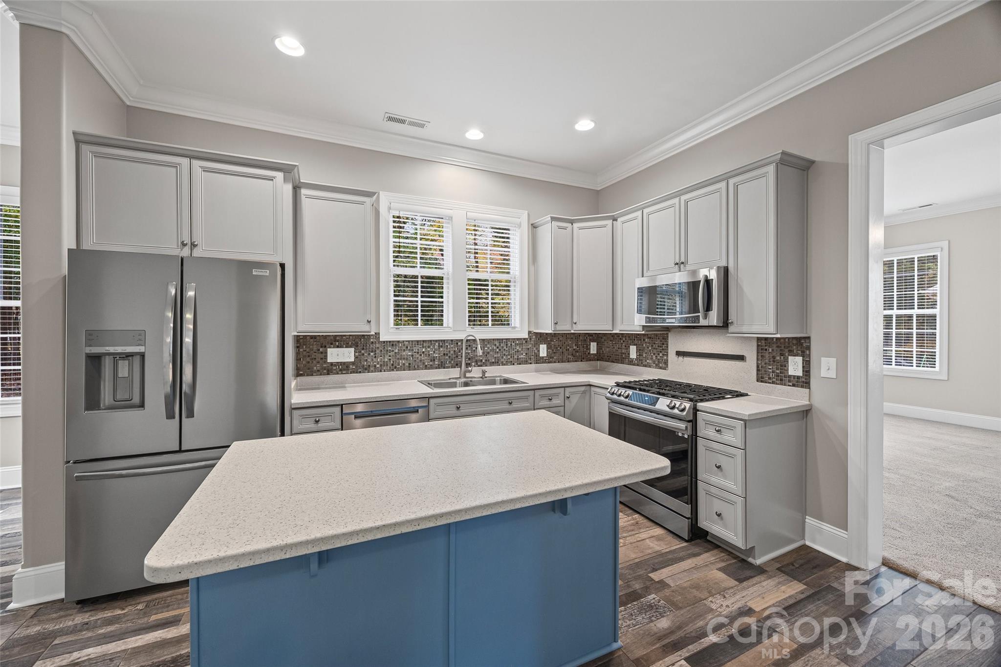 1576 Abercorn Street Northwest Concord, NC 28027 - Photo 23 of 48 a kitchen with kitchen island a counter top space a sink stainless steel appliances and cabinets
