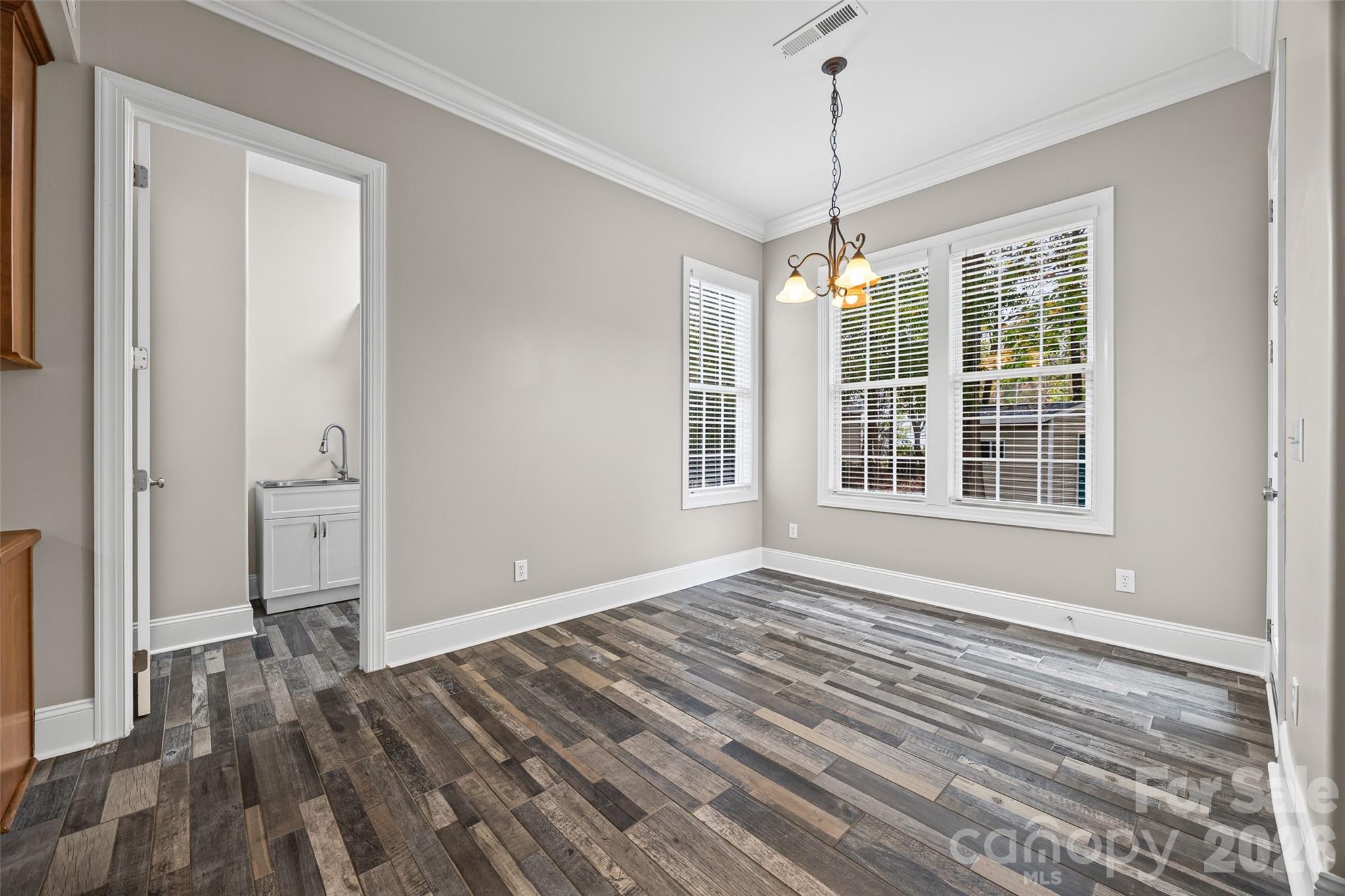 1576 Abercorn Street Northwest Concord, NC 28027 - Photo 26 of 48 a view of an empty room with wooden floor and a window