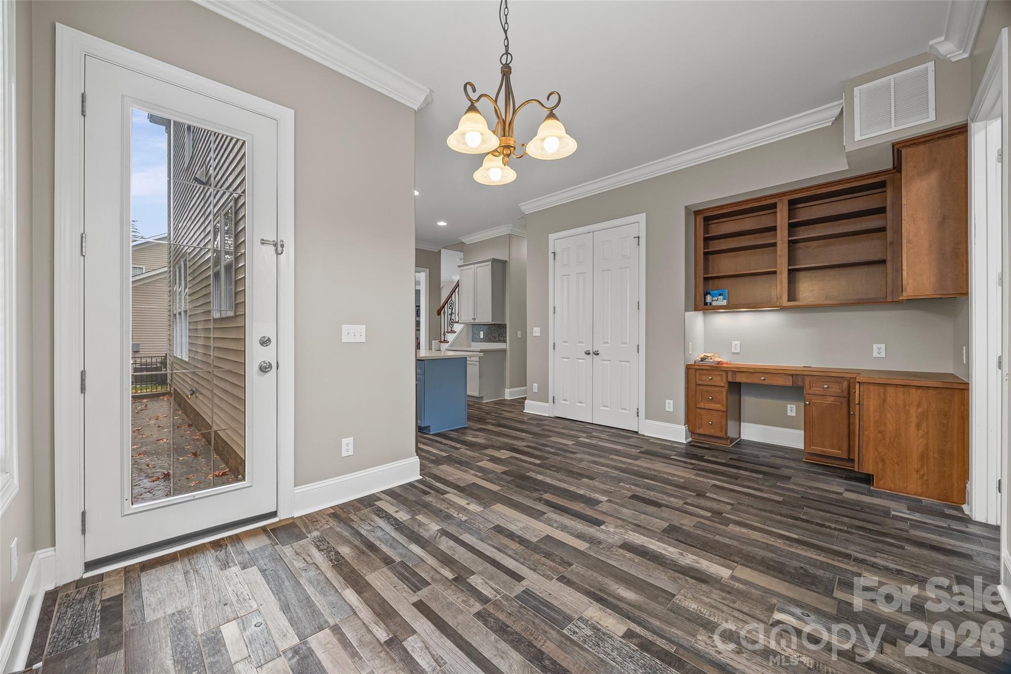1576 Abercorn Street Northwest Concord, NC 28027 - Photo 27 of 48 a view of a livingroom with wooden floor and a ceiling fan