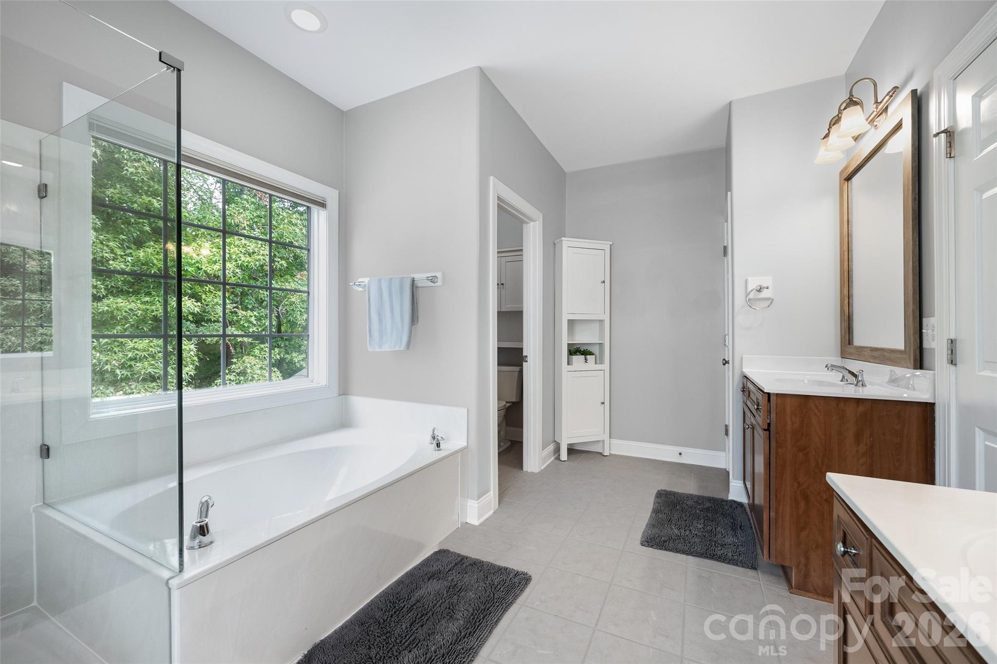 1576 Abercorn Street Northwest Concord, NC 28027 - Photo 32 of 48 a spacious bathroom with a tub sink and mirror