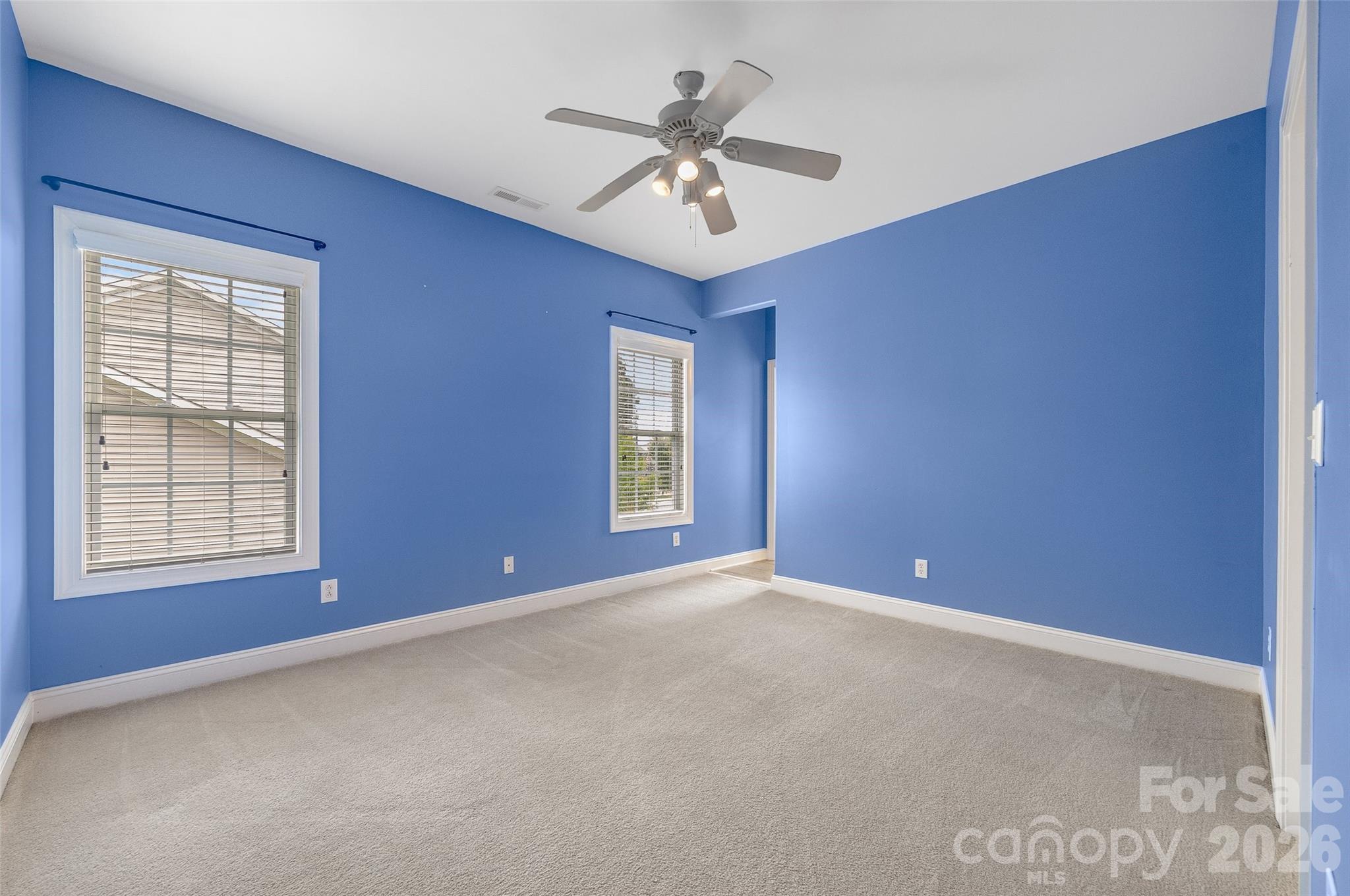 1576 Abercorn Street Northwest Concord, NC 28027 - Photo 34 of 48 a view of an empty room with chandelier fan and windows