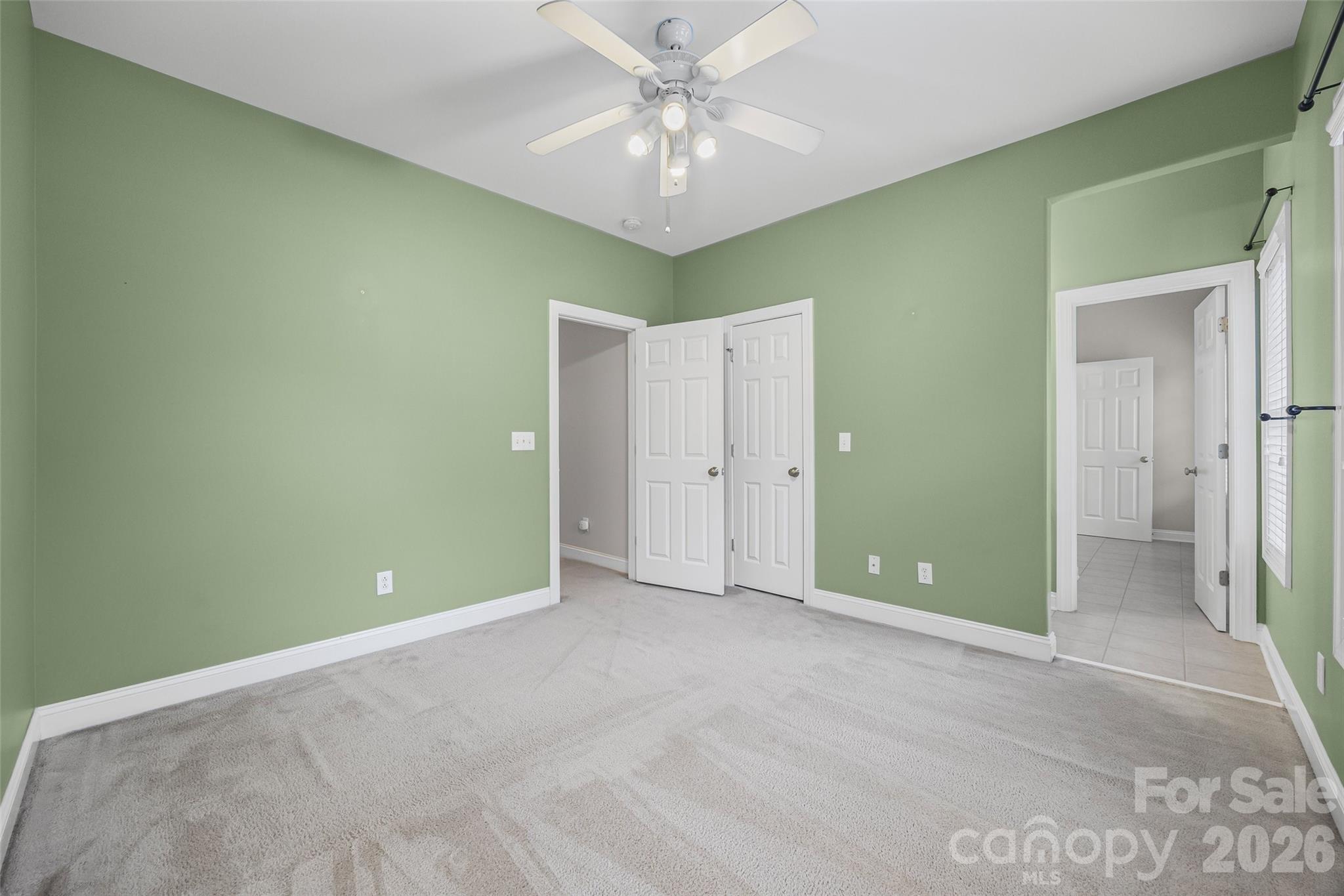 1576 Abercorn Street Northwest Concord, NC 28027 - Photo 40 of 48 a view of a room with a chandelier fan and closet area