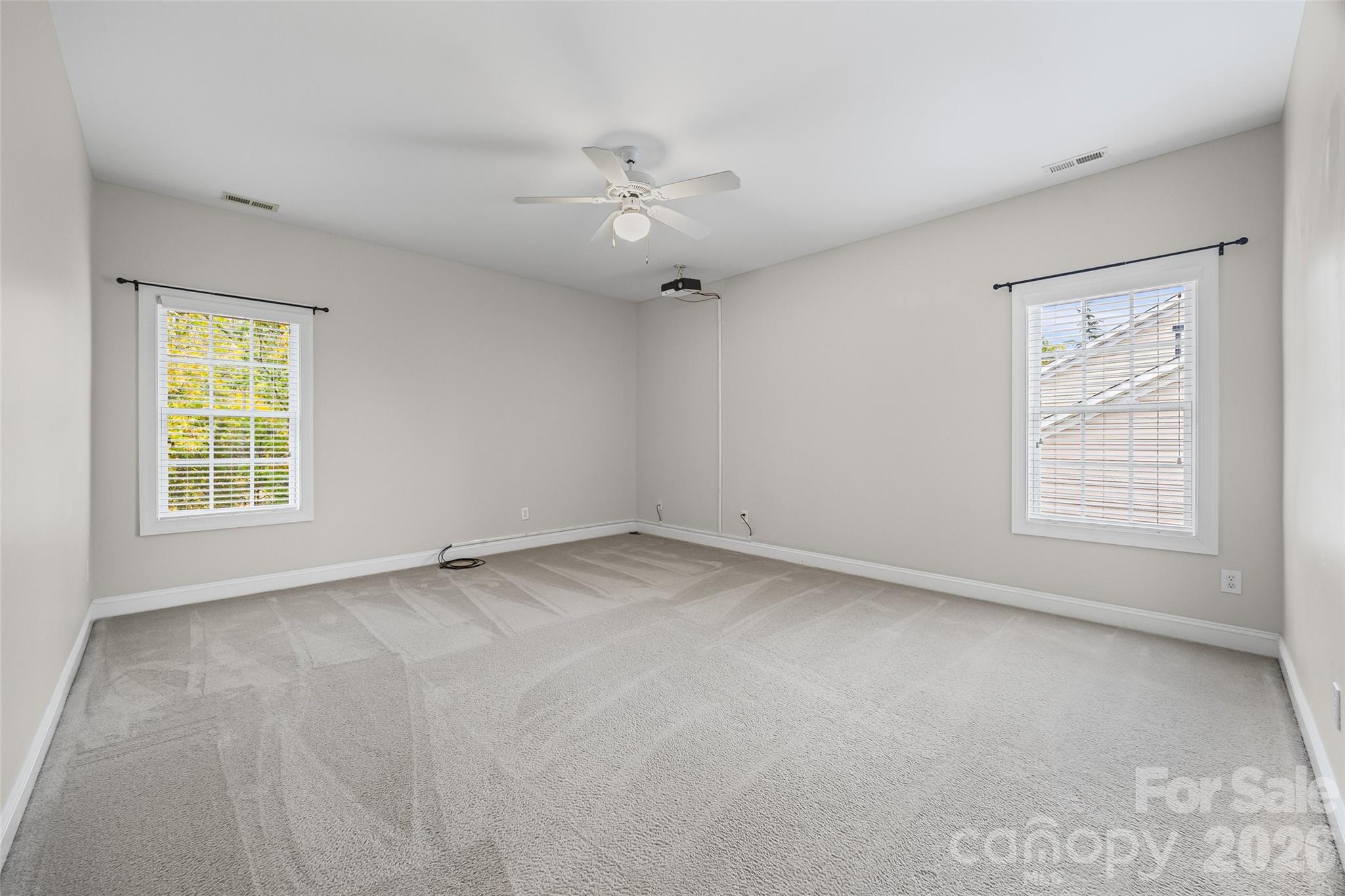 1576 Abercorn Street Northwest Concord, NC 28027 - Photo 42 of 48 an empty room with a window and ceiling fan