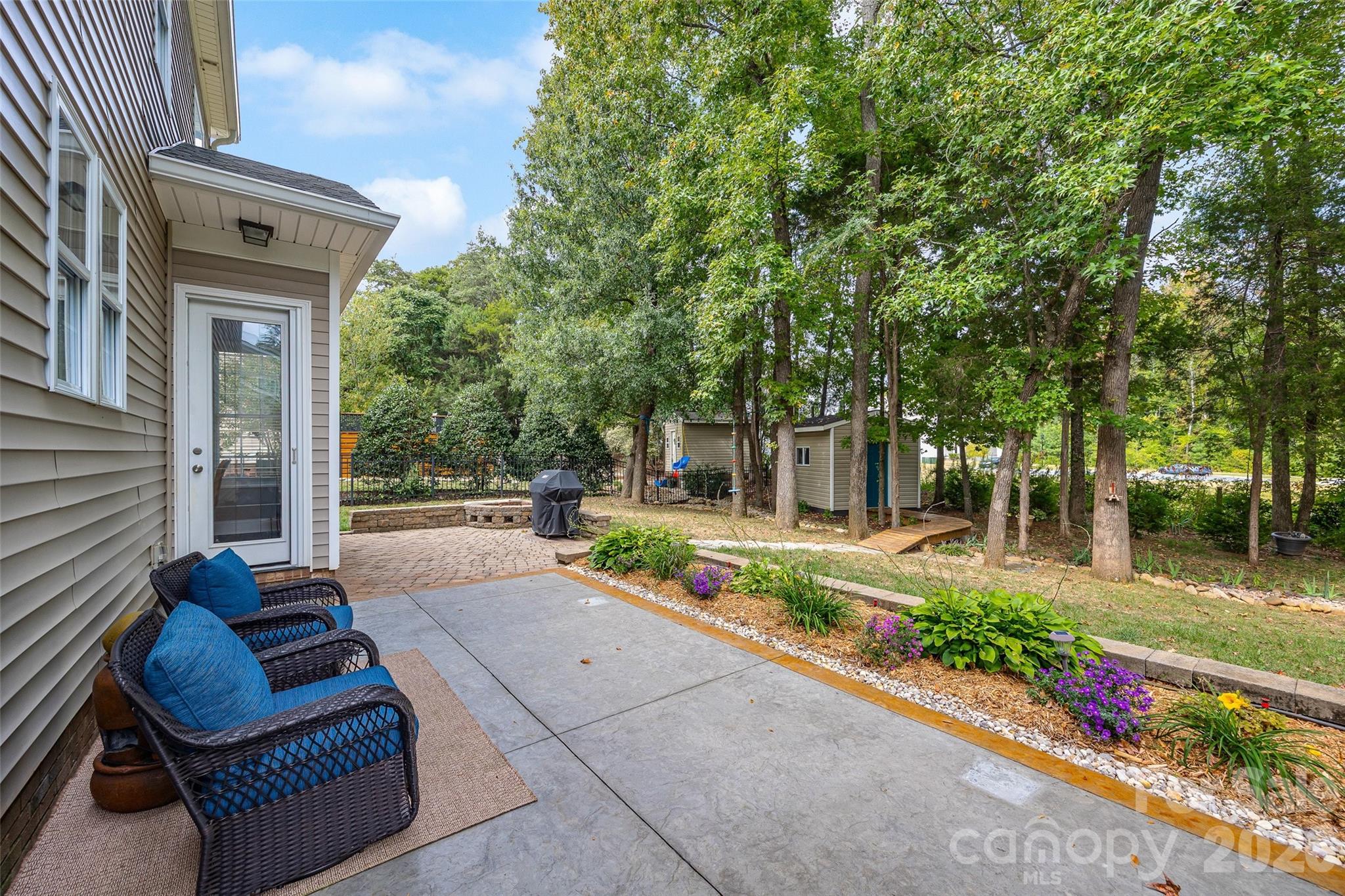 1576 Abercorn Street Northwest Concord, NC 28027 - Photo 6 of 48 a view of a patio with couches table and chairs and potted plants