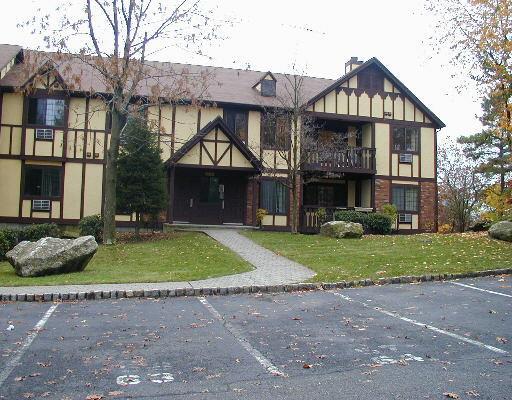 29 Roxbury Lane, Unit 121 Bridgeport, CT 06606 - Photo 1 of 1 a front view of a house with a yard and garage