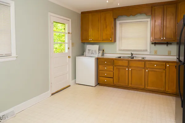 a kitchen with sink cabinets and window