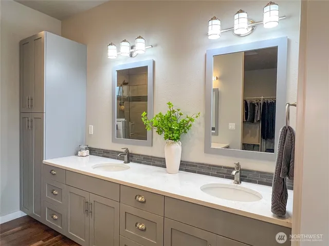 a bathroom with a sink double vanity and a mirror
