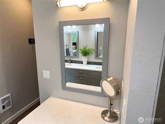 a bathroom with a mirror and sink
