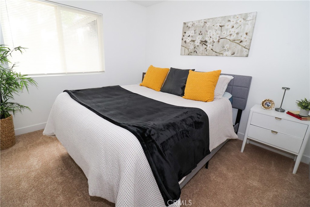 1161 Blue Ridge Lane Colton, CA 92324 - Photo 21 of 36 a bedroom with a bed and a painting on the wall
