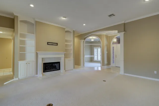 a view of an empty room with a fireplace