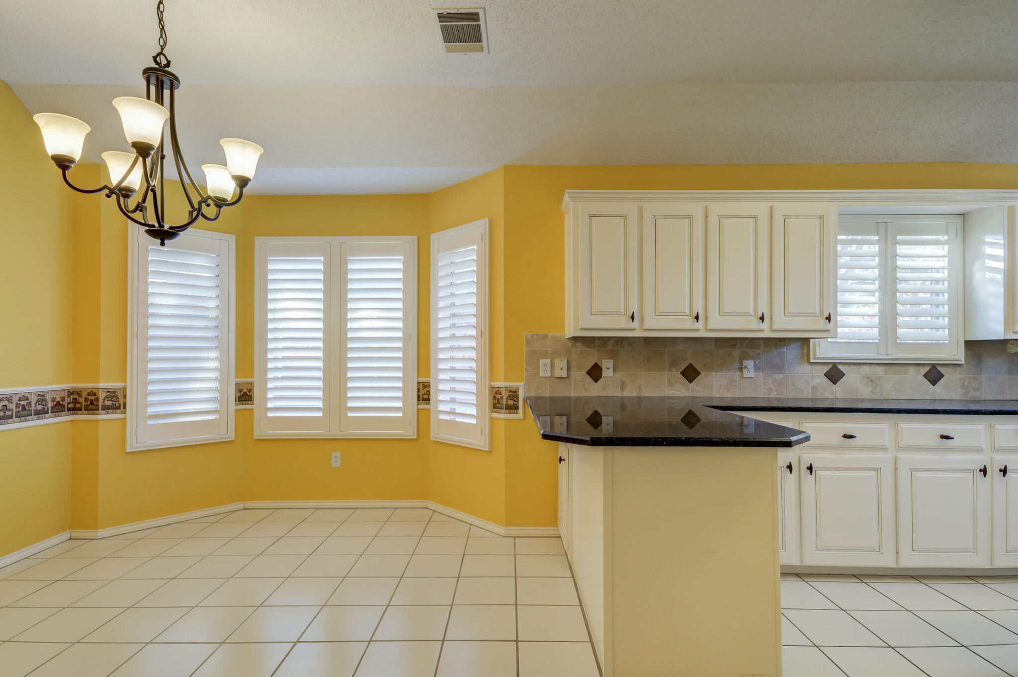 5917 85th Street Lubbock, TX 79424 - Photo 17 of 51 a kitchen with stainless steel appliances granite countertop a sink a stove cabinets and a window