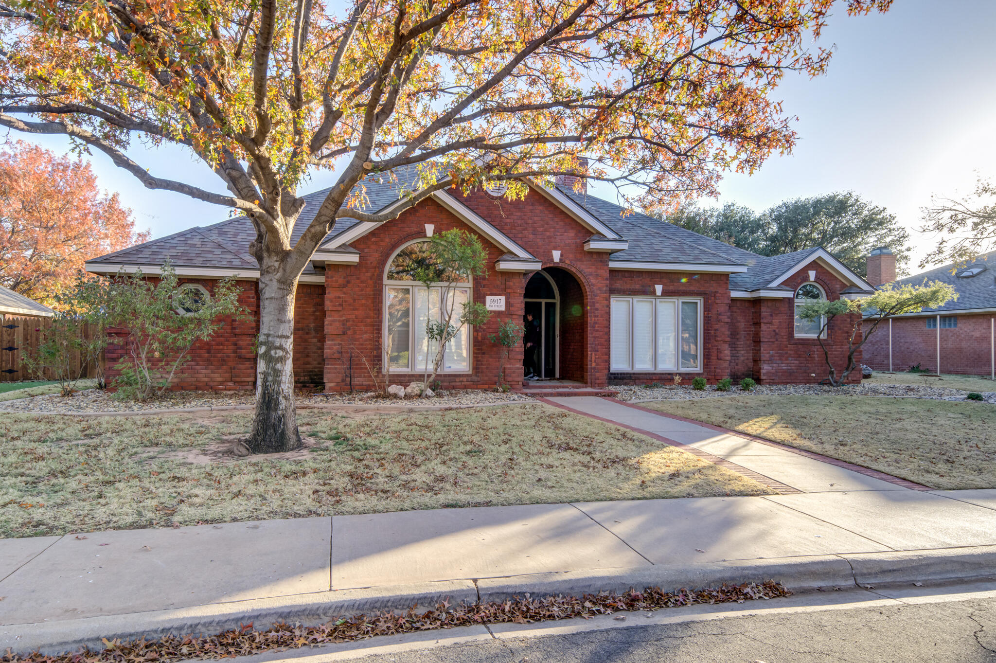 5917 85th Street Lubbock, TX 79424 - Photo 2 of 51 a front view of a house with garden
