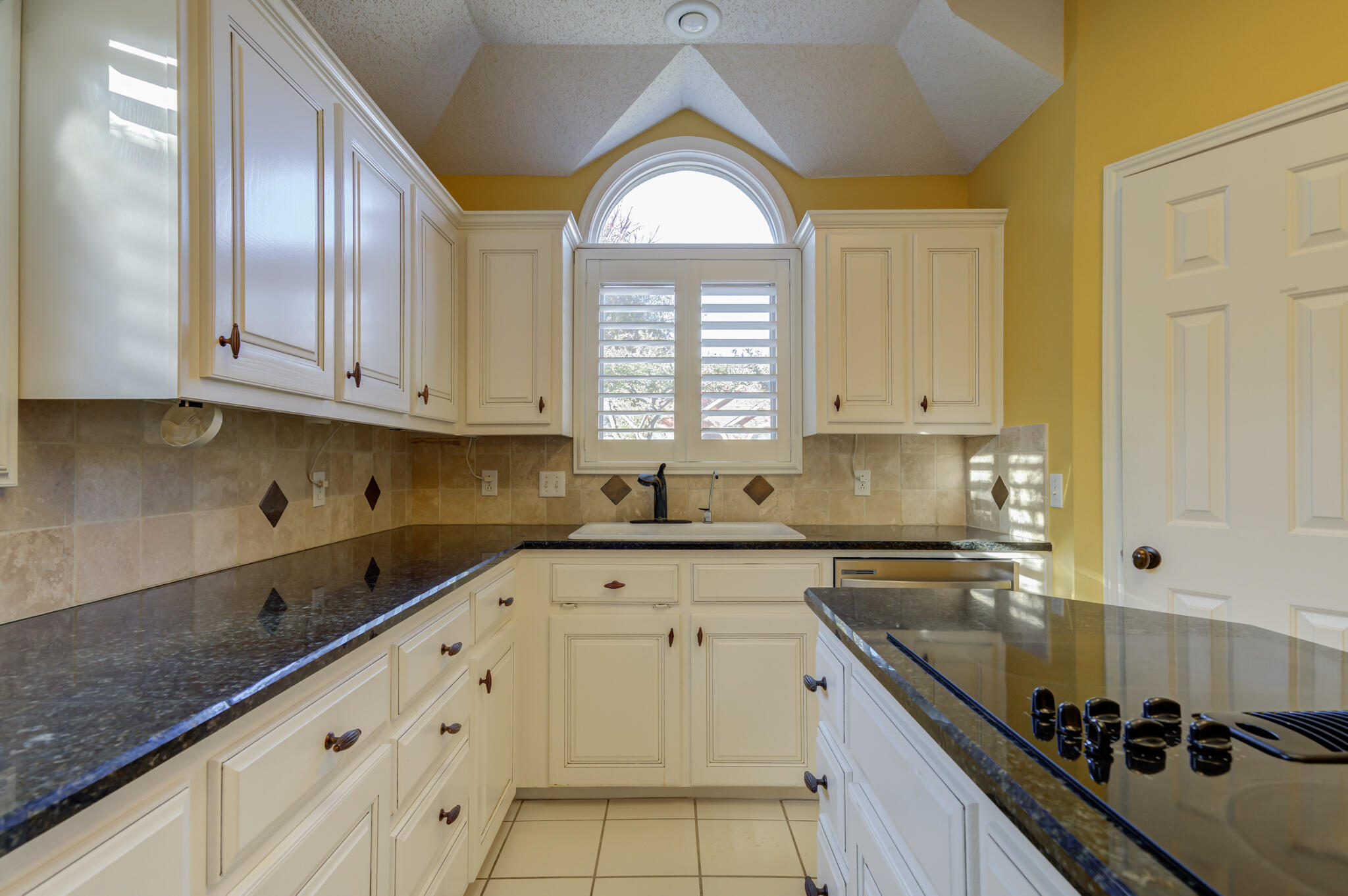 5917 85th Street Lubbock, TX 79424 - Photo 23 of 51 a kitchen with granite countertop a sink stainless steel appliances and cabinets
