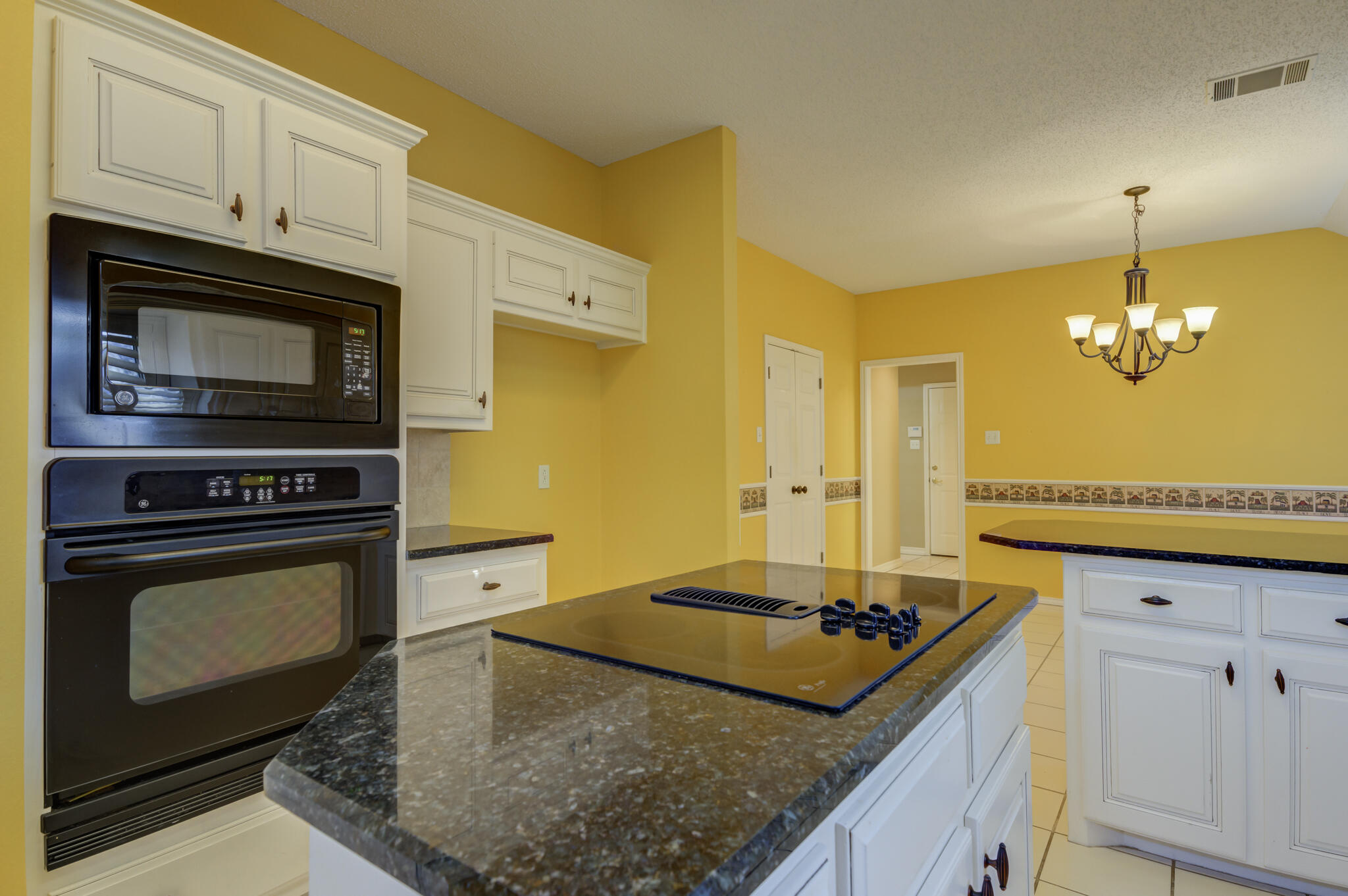 5917 85th Street Lubbock, TX 79424 - Photo 24 of 51 a kitchen with stainless steel appliances granite countertop a stove a sink and a microwave