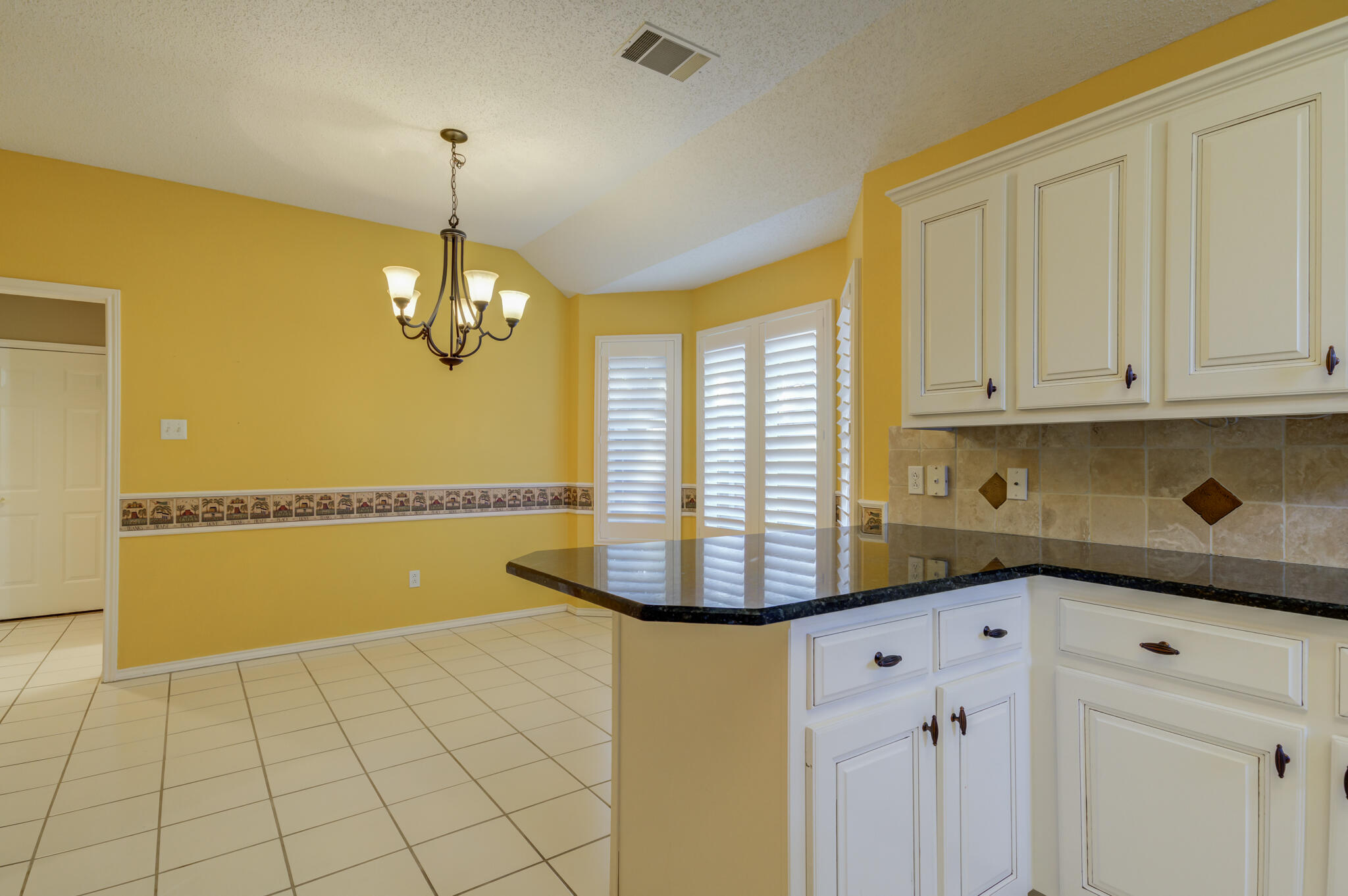 5917 85th Street Lubbock, TX 79424 - Photo 25 of 51 a view of a kitchen with a sink and dishwasher with white cabinets