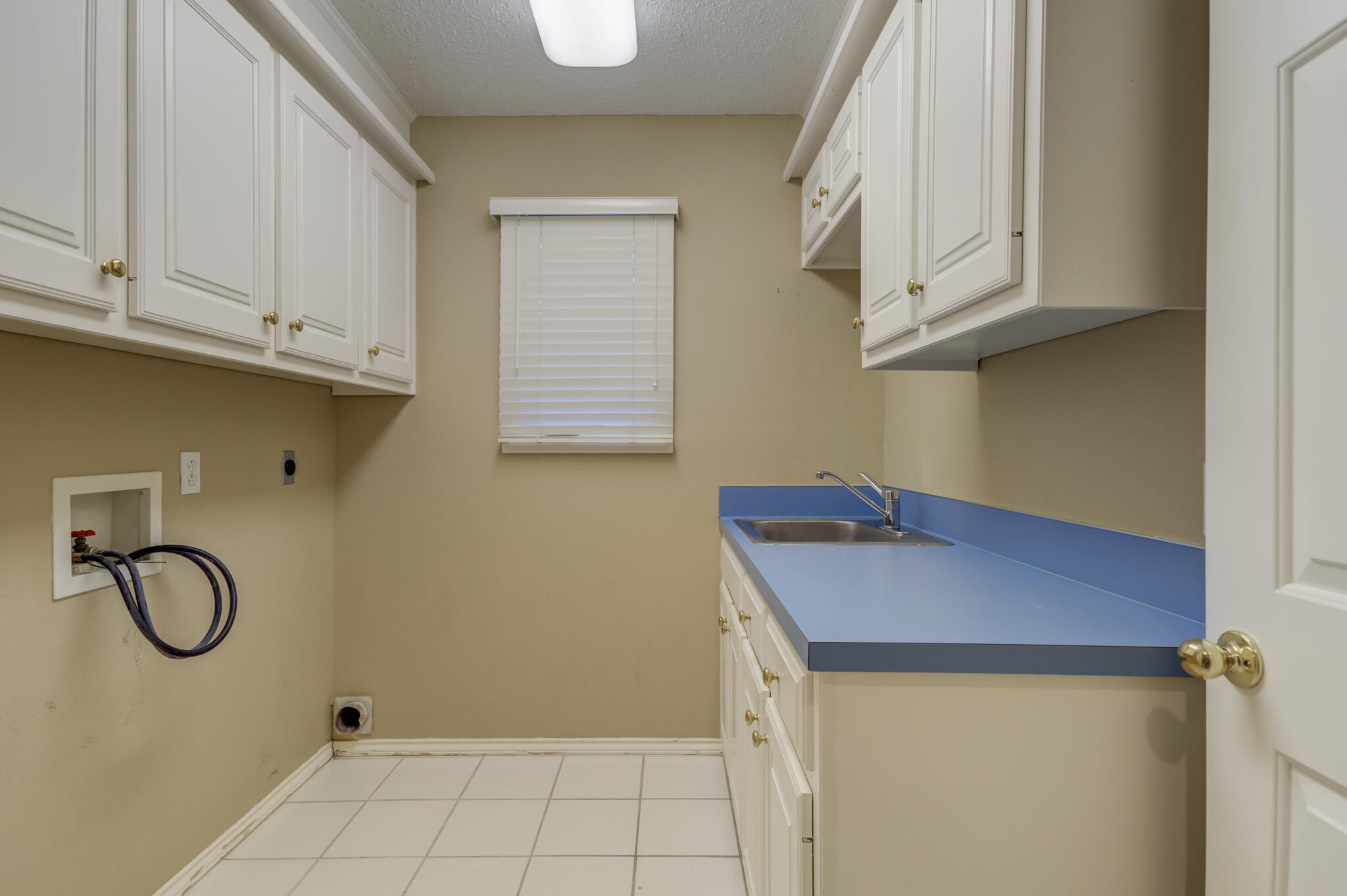 5917 85th Street Lubbock, TX 79424 - Photo 27 of 51 a room with white cabinets and a wooden floor