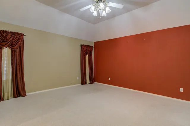 a spacious bathroom with a shower a sink and a mirror